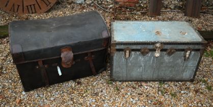 A vintage dome top motoring style trunk in 'tarred' protective sleeve with leather straps