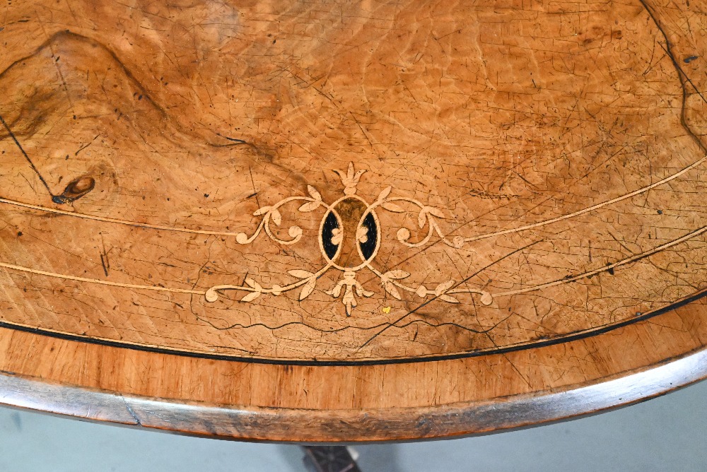 A Victorian inlaid figured walnut centre table, the oval top raised on four to swept legs, on - Image 6 of 6