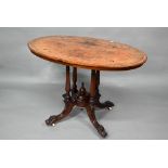 A Victorian inlaid figured walnut centre table, the oval top raised on four to swept legs, on
