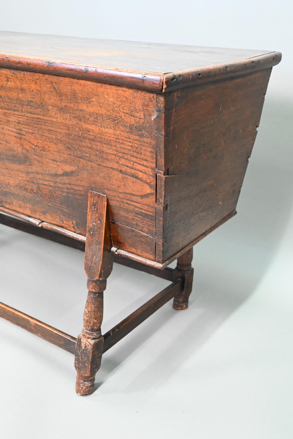 An antique oak dough bin, oak and walnut, the tapered body with single plank top, raised on part - Image 2 of 7