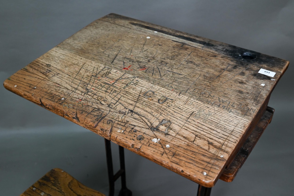 A Victorian cast iron and oak student/school desk, the slope top carved with multiple graffiti, - Image 3 of 7