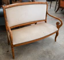 A stained beech framed salon settee with open scroll arms, champagne dralon upholstery