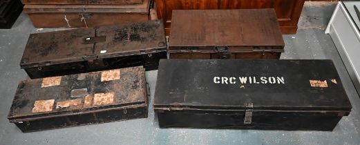 A stack of four antique and later japanned steel military uniform trunks, variously labelled incl.