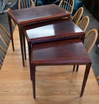 A nest of three mid-century rosewood tables, the largest 60 cm wide x 36 x 50 cm high