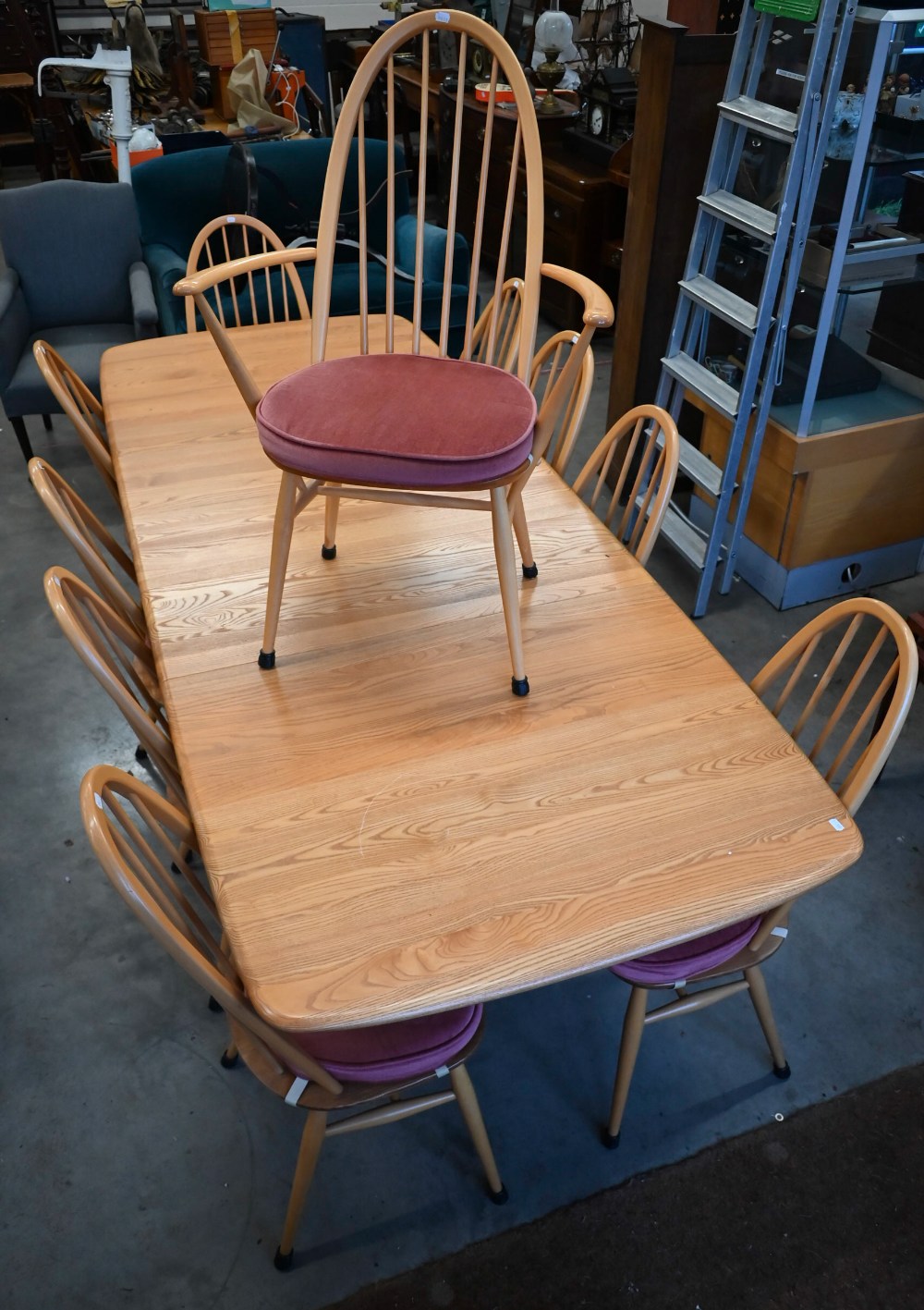 A modern Ercol Grand Windsor ash extending dining table with three optional central leaves (model