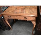 A reproduction walnut side table with frieze drawer and cabriole supports with pad feet, 92 x 48 x