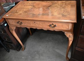 A reproduction walnut side table with frieze drawer and cabriole supports with pad feet, 92 x 48 x