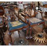 A set of mahogany Chippendale-style dining chairs with ball and claw feet and sabre back legs,