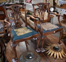 A set of mahogany Chippendale-style dining chairs with ball and claw feet and sabre back legs,