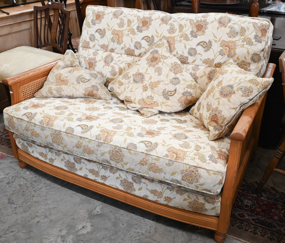 An Ercol ash and woven cane bergere three piece suite, two seater sofa and pair of armchairs, - Image 6 of 6