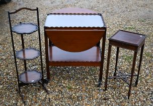 A vintage three-tier folding cake-stand to/with a traditional tea trolley and a Sheraton Revival