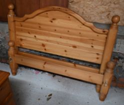 A stained pine double bed frame, 150 cm wide