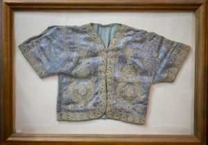 A vintage Northern Indian embroidered jacket with gold and silver thread on a blue ground, in glazed