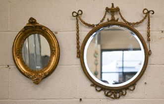 A bevelled circular wall mirror in decorative neoclassical style gilt frame, 45 cm diam to/w smaller