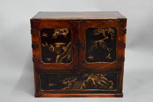 A Japanese part gilt and black lacquered table cabinet, late 19th century, the twin doors