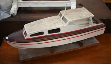 A painted wood model motor-yacht with electric motor, 75 cm long, on stand