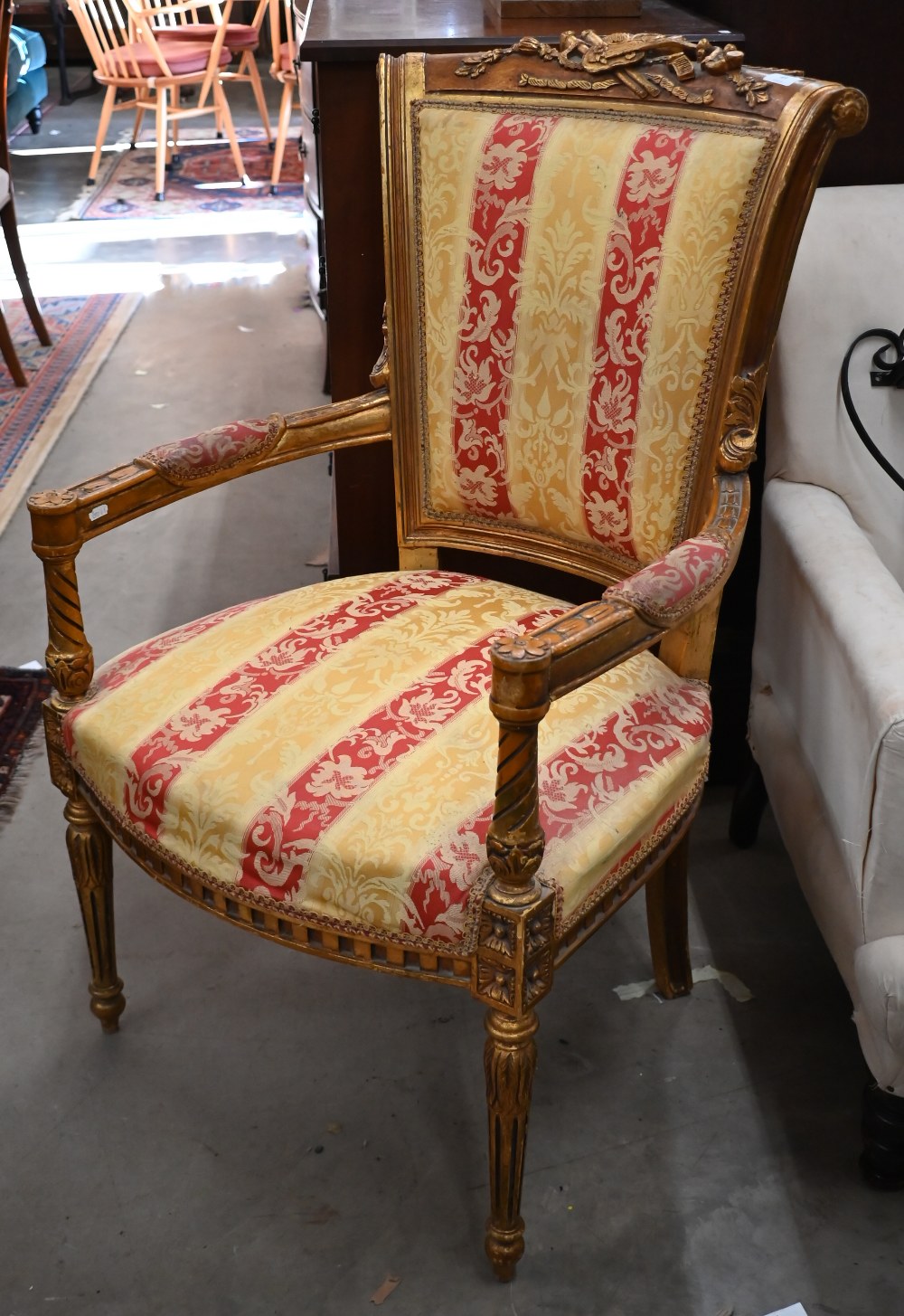 A French style giltwood framed fauteuil armchair, floral and foliate striped damask fabric