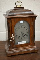 An antique French oak mantel clock with silvered dial inscribed for Ramsay of Dundee, striking on