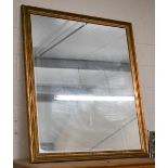 A large rectangular wall mirror in moulded aged giltwood frame, 136 x 118 cm