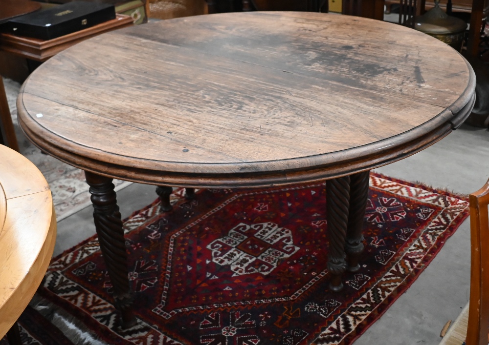 A 19th century mahogany circular campaign dining table on spiral turned supports