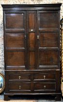 An 18th century and later composed oak two section linen cupboard, the pair of joint framed triple