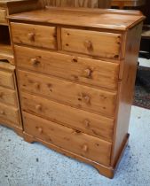A modern pine tallboy chest of two short over four long graduated drawers, on shaped bracket feet,