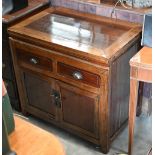 A Chinese stained and lacquered hardwood side cabinet with two drawers over panelled cupboards, 80