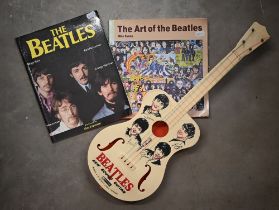 A Selcol plastic 'Beatles New Sound Guitar' to/w two paperback volumes 'The Art of the Beatles' by