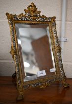 A Continental gilt and silvered brass easel mirror with bevelled plate and ornate pierced frame