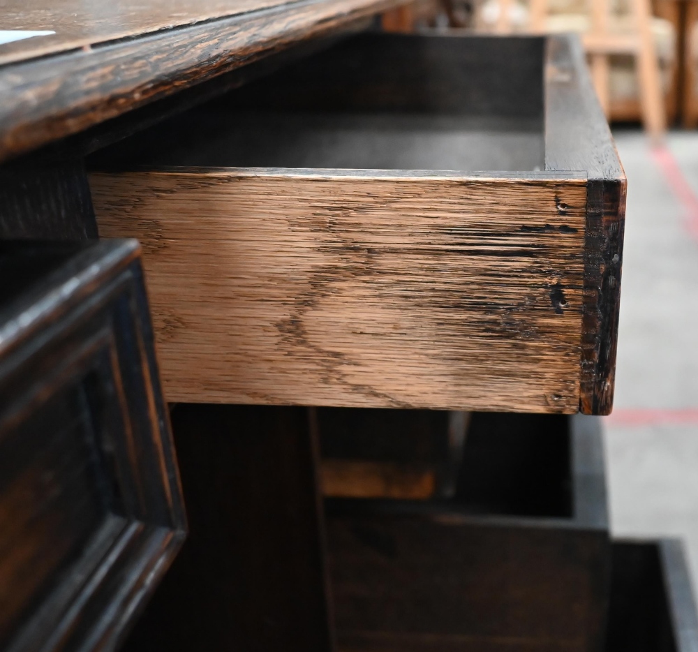 An early 20th century oak Jacobean style kneehole desk, eight drawers around central niche with - Image 4 of 4