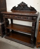 A late Victorian carved oak buffet with raised back, single drawer and open shelves, 120 x 52 x