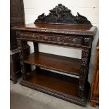 A late Victorian carved oak buffet with raised back, single drawer and open shelves, 120 x 52 x
