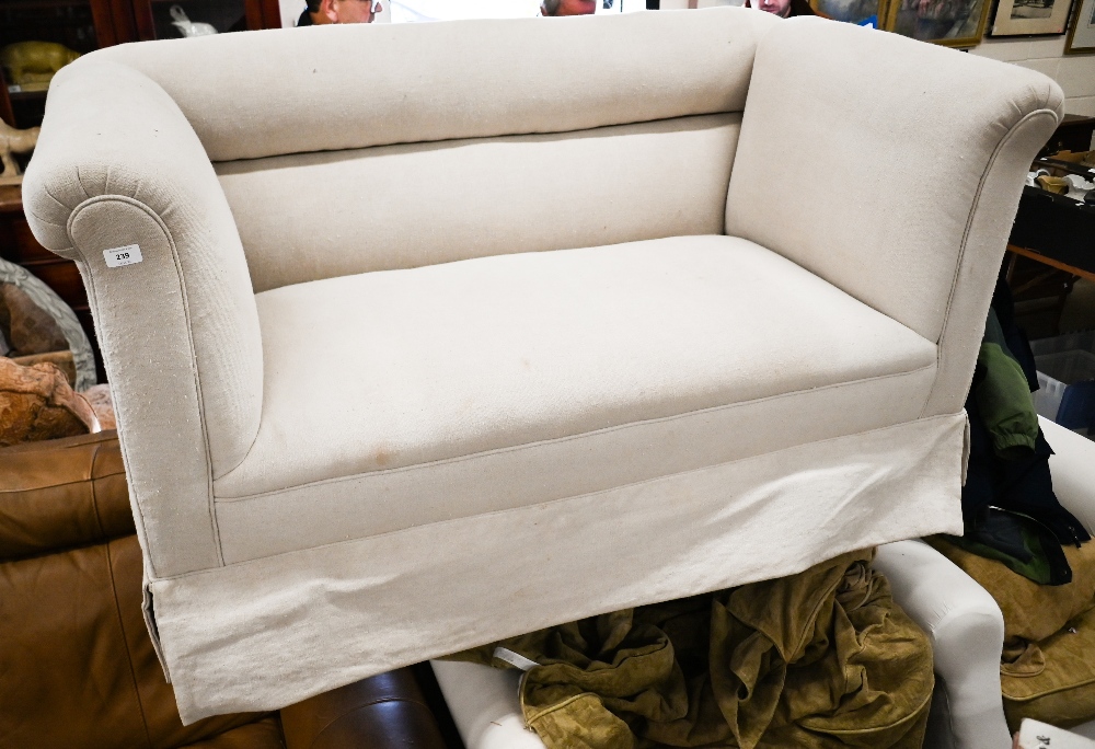 An Edwardian two seater sofa on tapering square supports and casters, cream linen fabric, 150 cm