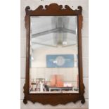 A 19th century bevelled wall mirror in fret-cut walnut frame, 65 cm wide x 114 cm high