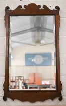 A 19th century bevelled wall mirror in fret-cut walnut frame, 65 cm wide x 114 cm high