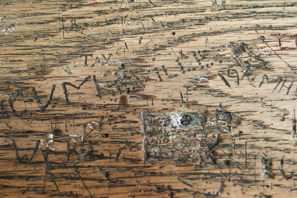 A Victorian cast iron and oak student/school desk, the slope top carved with multiple graffiti, - Image 5 of 6