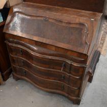 An antique Continental walnut fall front bureau with three long drawers standing on shaped bracket