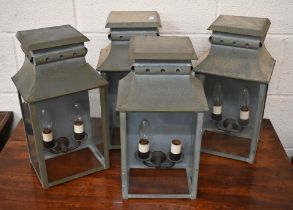A set of four Hector Finch aged metal glazed twin sconce wall lanterns