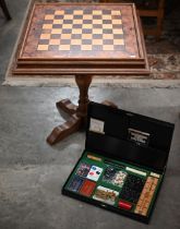 A walnut inlaid games table for chess, cards and backgammon 62 cm square to/w a boxed games