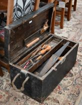 A stained wood box containing a quantity of vintage tools