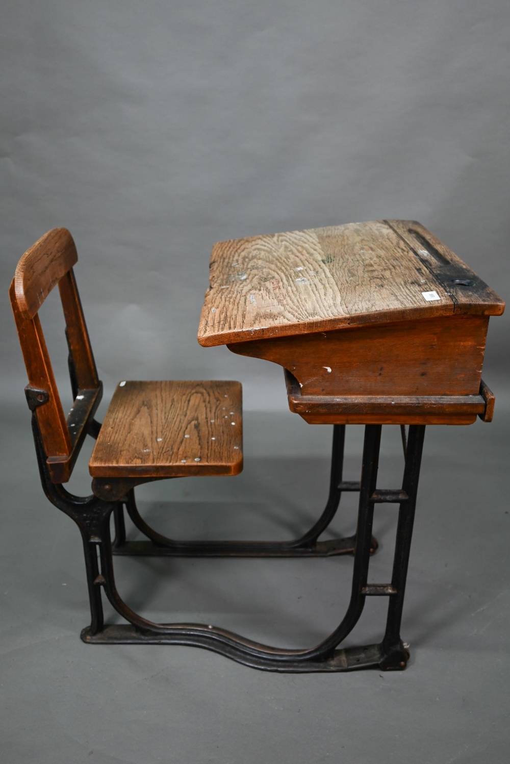 A Victorian cast iron and oak student/school desk, the slope top carved with multiple graffiti, - Image 2 of 6