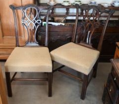A set of six carved mahogany Chippendale style dining chairs with beige diamond-weave pattern