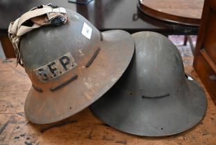 Two World War II British Civil Defence Kuckermann steel helmets - one stencilled 'SFP' (2)