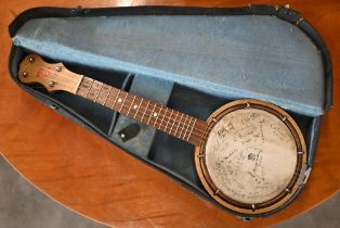 A cased vintage ukelele-banjo, the skin with various signatures (1928)