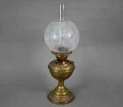 A Victorian brass oil lamp with etched glass shade and patent Duplex burner