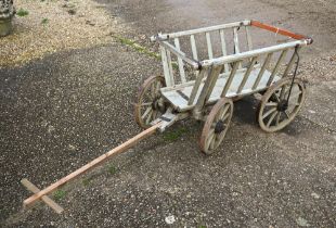 A vintage wooden dog cart, with four steel banded wood spoke wheels, a/f