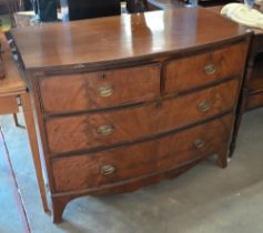 A 19th century mahogany bowfront chest of two short over two long drawers over shaped apron raised