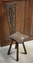 A carved wheelback spinners chair in the traditional style