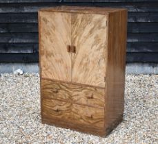 An Art Deco period walnut press cupboard over two graduated drawers, on a plinth base, 75 cm x 50 cm