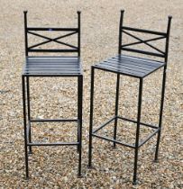 A pair of modern black painted steel bar stools (2)